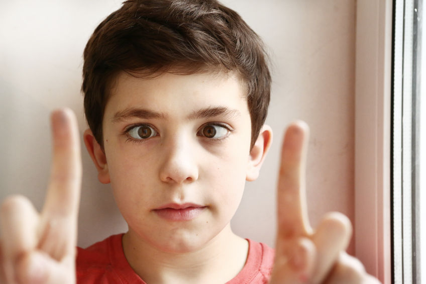 Boy crossing his eyes, showing convergent strabismus